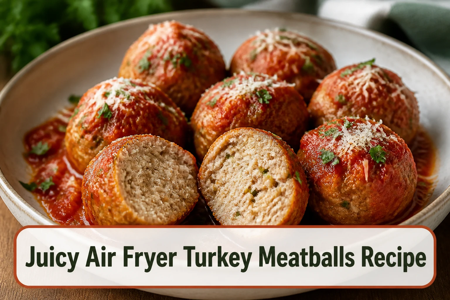 Golden air-fried turkey meatballs with marinara, parsley and grated Parmesan in a shallow ceramic bowl, one meatball cut open to show moisture.; title text reads Juicy Air Fryer Turkey Meatballs Recipe