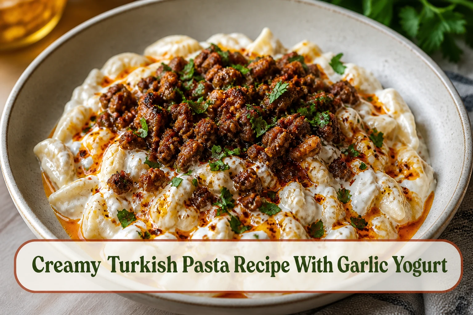 Creamy Turkish-inspired pasta with garlic yogurt, browned paprika beef, red butter drizzle and fresh herbs in a wide bowl.; title text reads Creamy Turkish Pasta Recipe With Garlic Yogurt